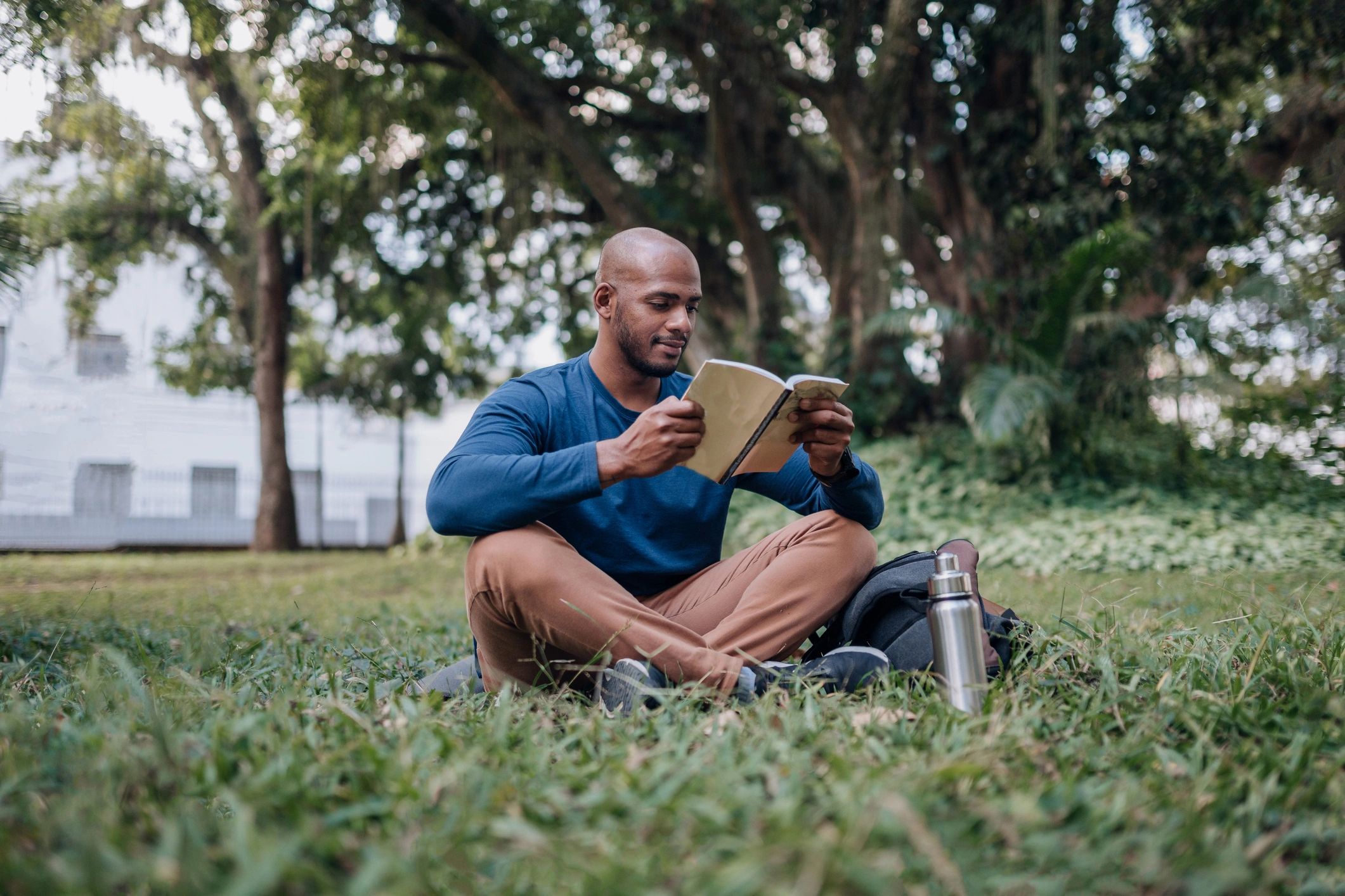 Person reading outdoors in a park