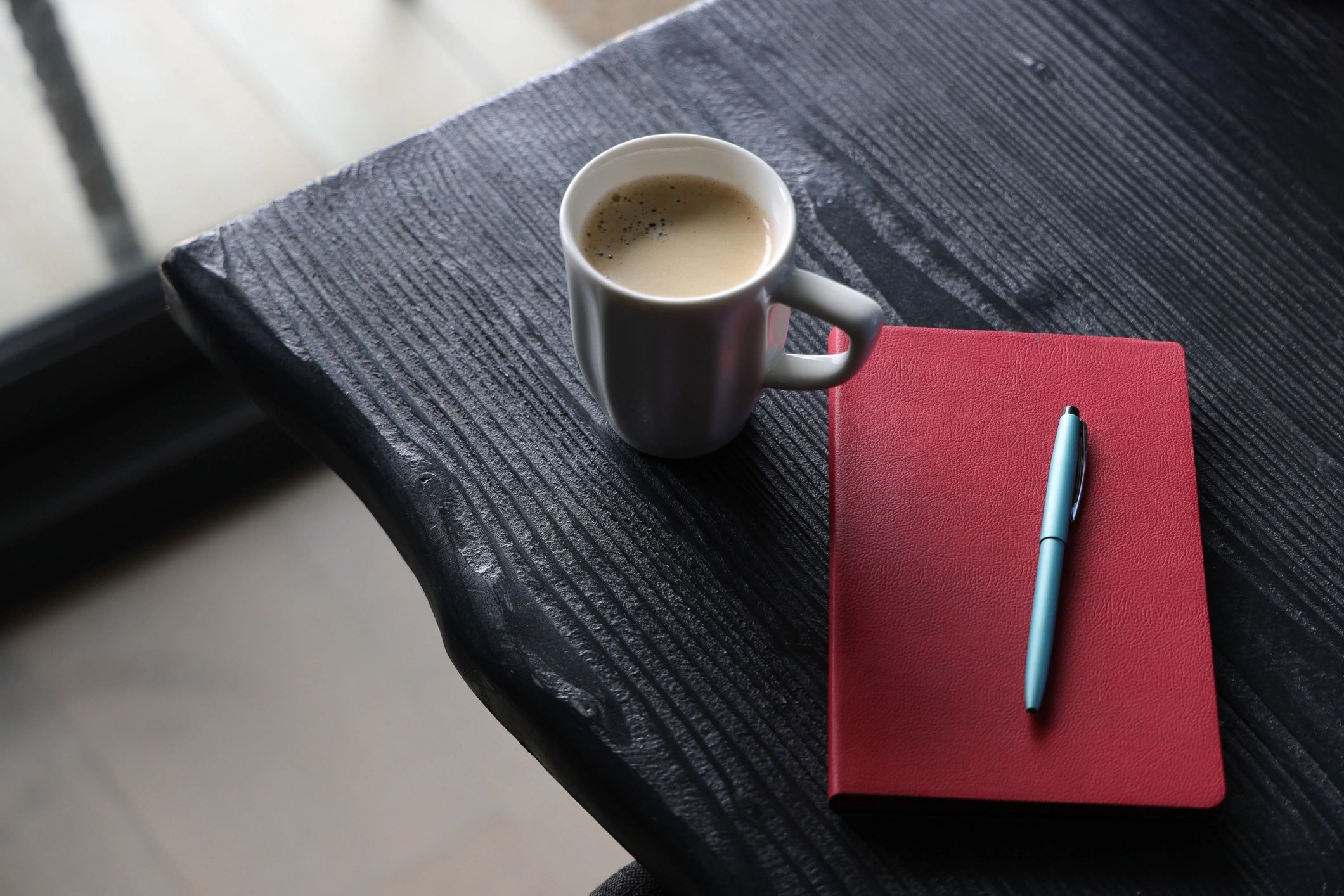 Notebook and coffee on a desk, representing structured learning and study notes