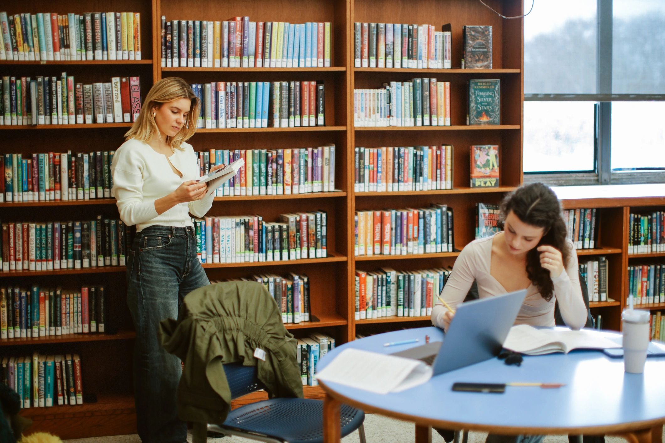Students studying in a library, representing research and evidence-based learning