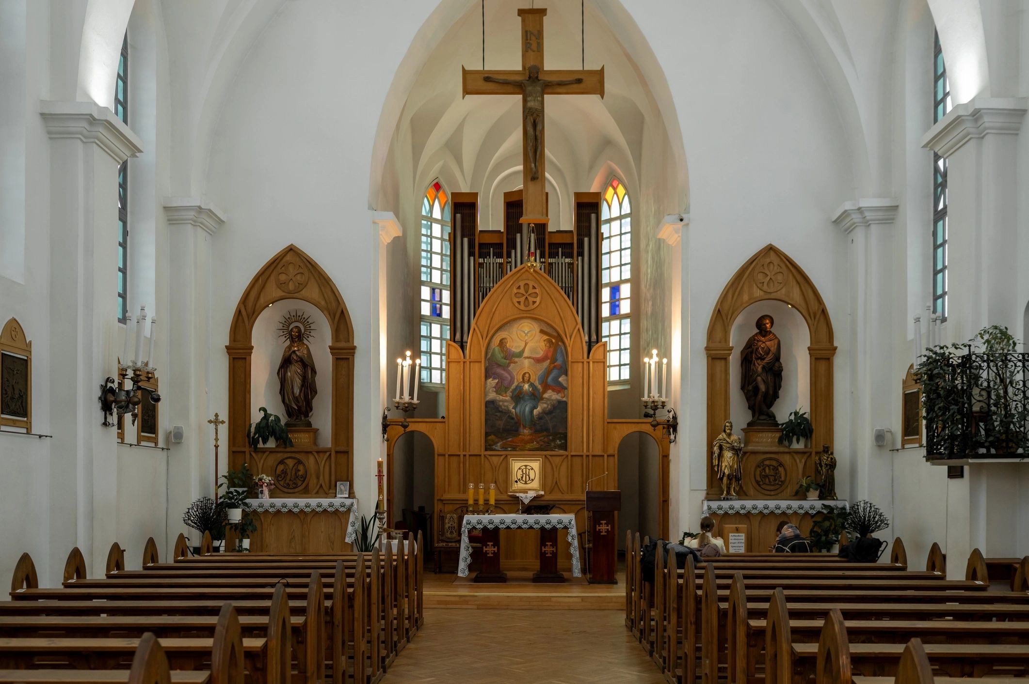 Wide view of a church interior with pews and altar